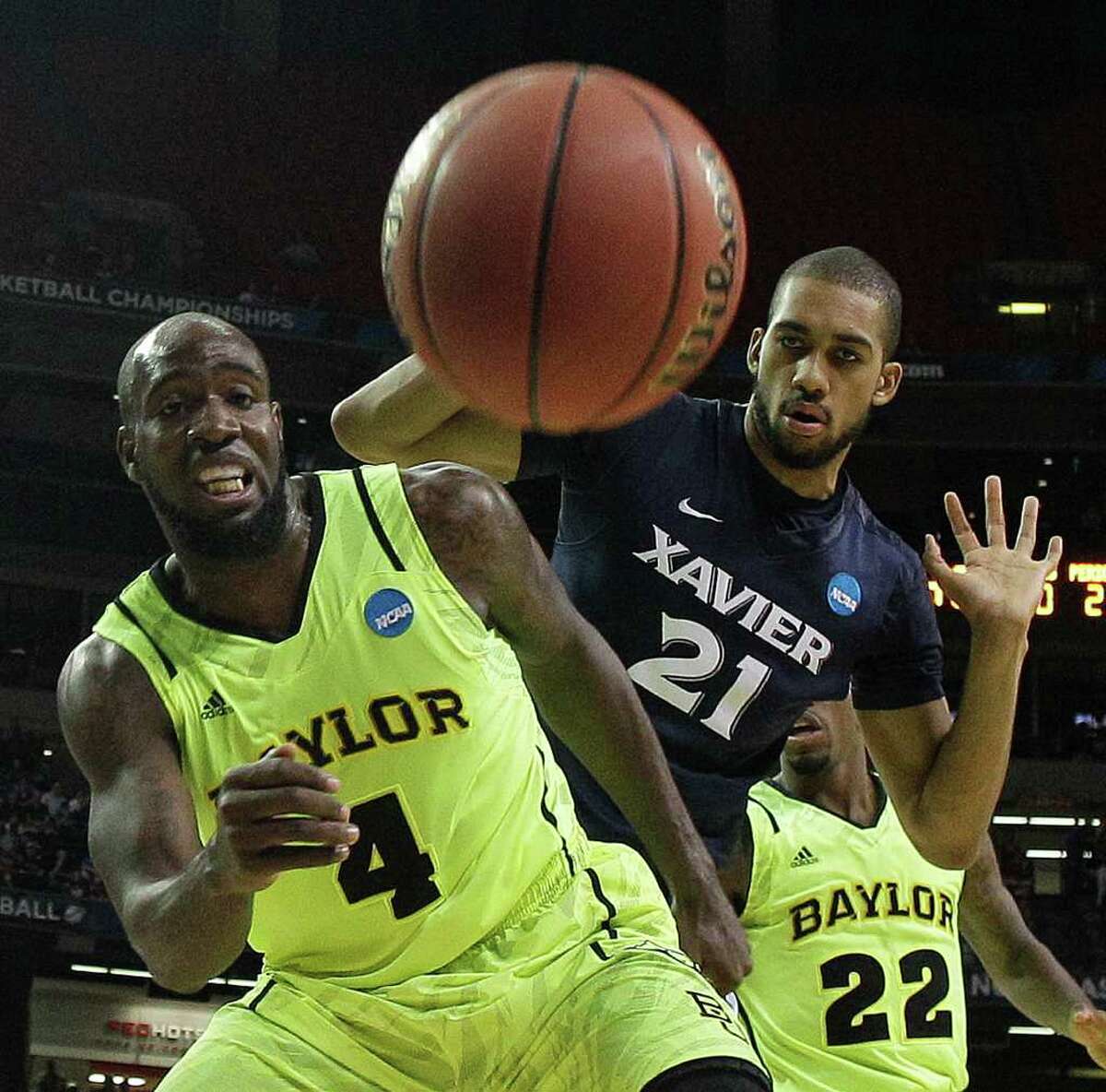 Baylor's Quincy Acy (4) and Xavier's Jeff Robinson (21) vie for a loose ball as Baylor's A.J. Walton looks on during the second half of an NCAA tournament South Regional semifinal college basketball game Friday, March 23, 2012, in Atlanta. (AP Photo/John Bazemore)
