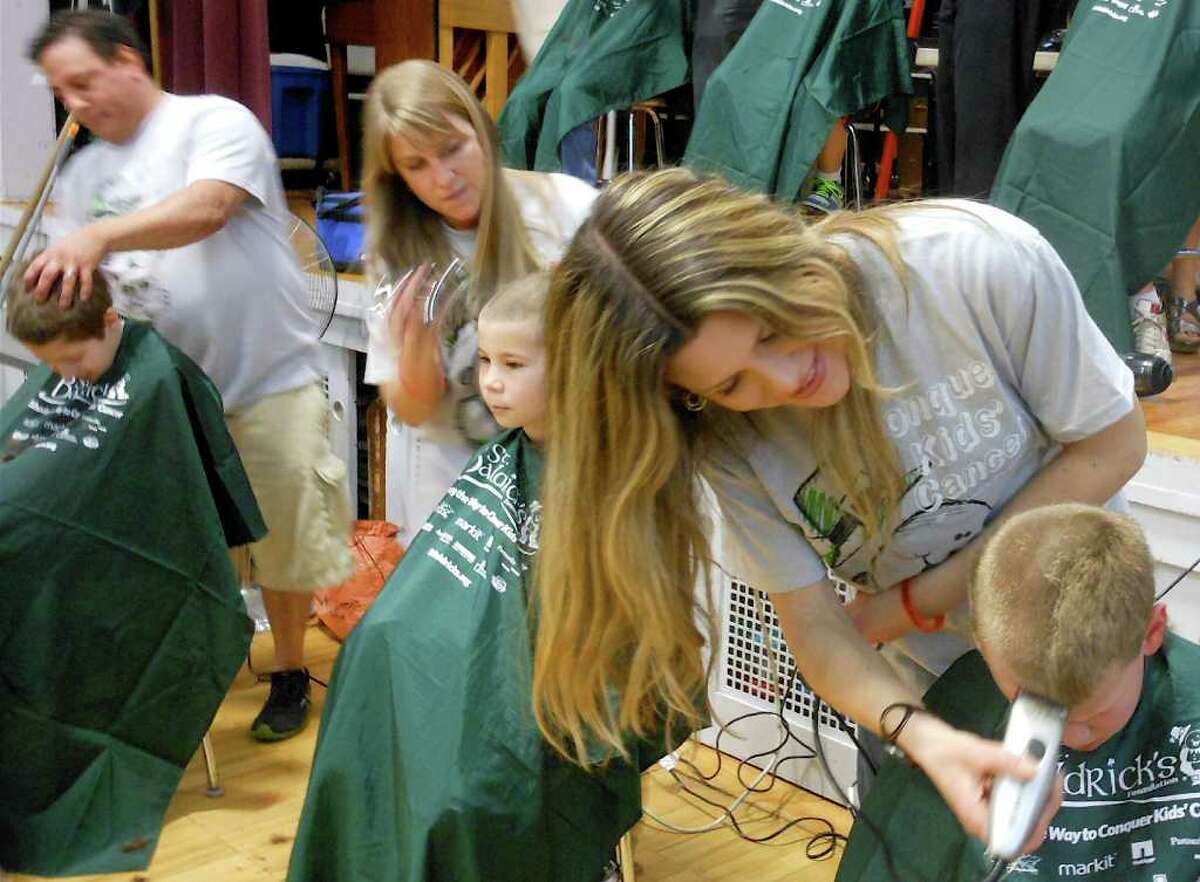 Haircutters from Salon Isa buzz younsters' heads Friday at the Osborn Hill School fundraiser for the cancer charity, St. Baldrick's Foundation.
