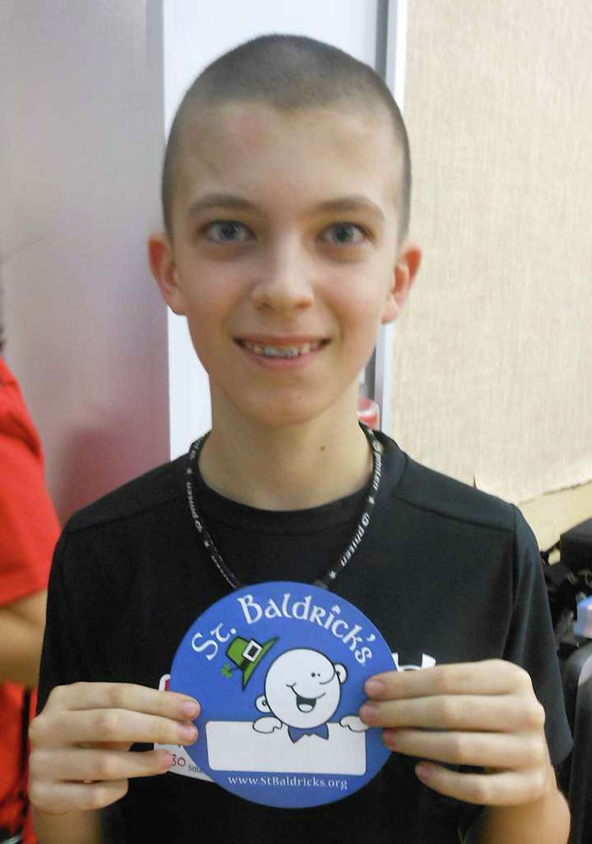 Ten-year-old Mark Handler, with his freshly shaven head Friday, was a former Osborn Hill classmate of Teddy Gerber's, who lost his battle with cancer in 2010.