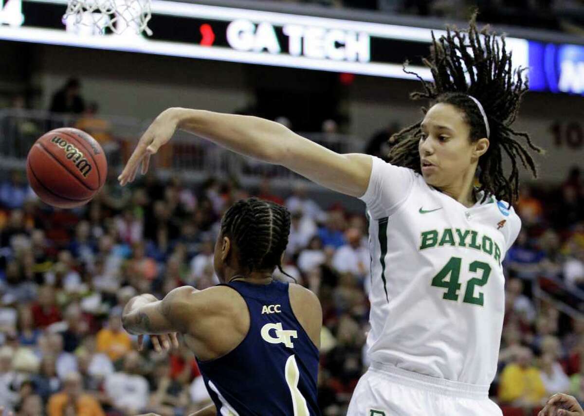 Baylor center Brittney Griner, right, tries to block a shot by Georgia Tech guard Dawnn Maye during the first half of an NCAA women's tournament regional semifinal college basketball game, Saturday, March 24, 2012, in Des Moines, Iowa. (AP Photo/Charlie Neibergall)