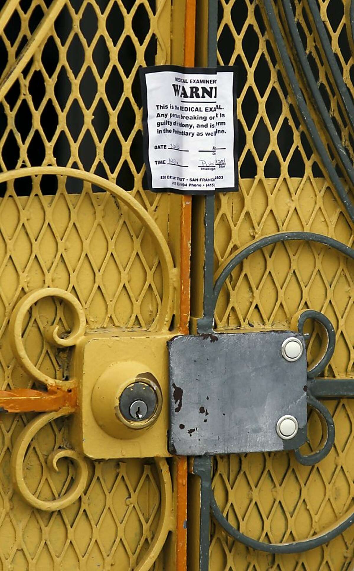 A medical examiner sticker seals the front door of 16 Howth Street, the site of a quintuple murder, on Monday, March 26, 2012 in San Francisco, Calif.