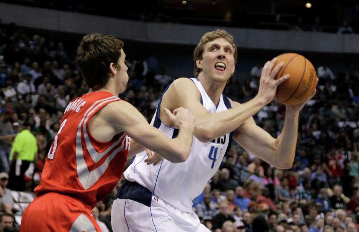Dallas Mavericks' Dirk Nowitzki (41) of Germany positions to shoot against Houston Rockets' Goran Dragic (3) of Slovenia in the first half of an NBA basketball game Tuesday, March 27, 2012, in Dallas. (AP Photo/Tony Gutierrez)