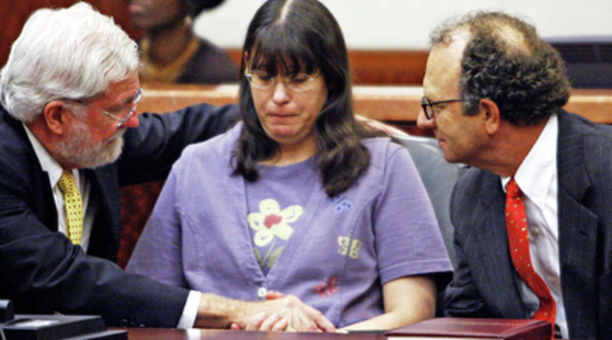 Andrea Yates, flanked by her lawyers George Parnham, left, and Wendell Odom, looks on after she was found not guilty by reason of insanity in her second murder trial for the 2001 bathtub drownings of her young children, Wednesday, July 26, 2006, in Houston.