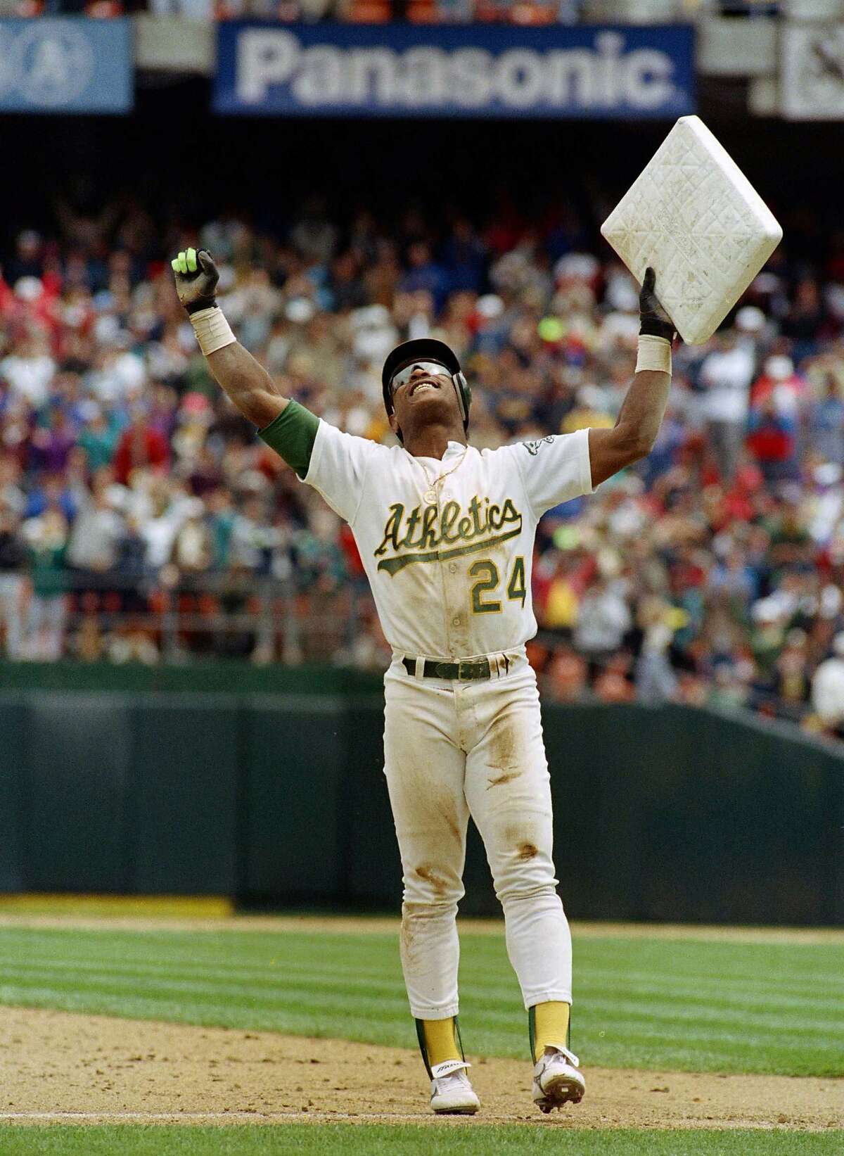 ** FILE ** In this May 1, 1991, file photo, Oakland Athletics' Rickey Henderson celebrates and raises third base after setting the all-time stolen base record during the Athletics' baseball game in Oakland, Calif., against the New York Yankees. The stolen base was Henderson's 939th, moving him past Lou Brock. Henderson was voted into baseball's Hall of Fame on Monday, Jan. 12, 2009. (AP Photo/Eric Risberg, File)
