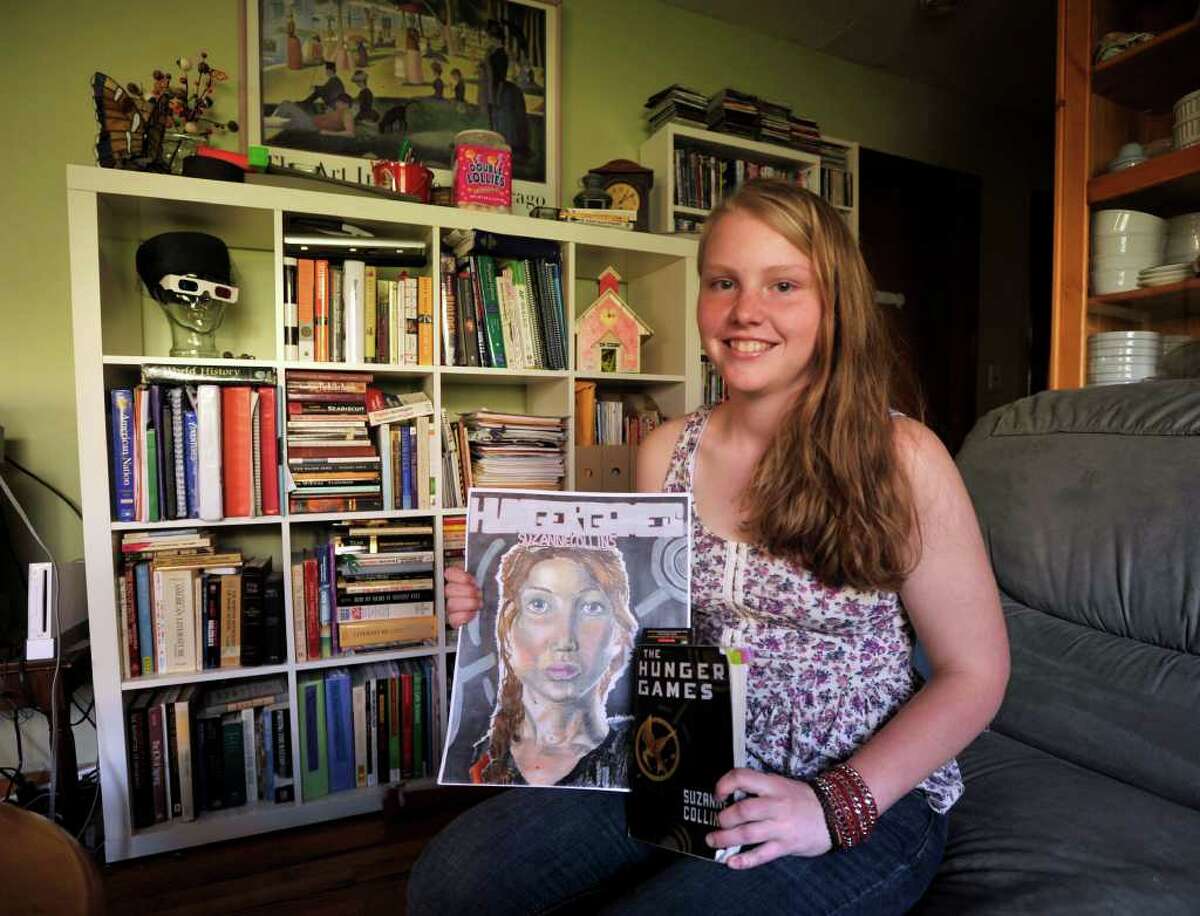 Eilish Nobes, 15, of Danbury, is halfway through illustrating her graphic novel based on the book and movie, "The Hunger Games." Nobes is seen here at her home in Danbury on Tuesday, March 27, 2012.