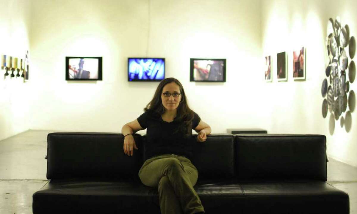 Guillermina Zabala poses for a photo in the Blue Star gallery where her exihibit "Juanito" is on display.