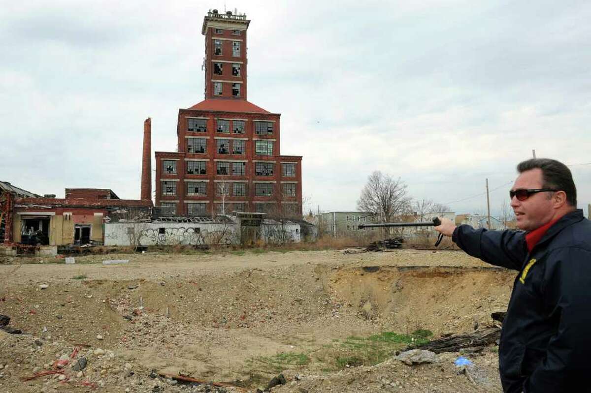 City Council member Robert Curwen points to a large crater on the Remington Arms property, in Bridgeport, Conn. March 28th, 2012. Several buildings on the site are being prepared for demolition.