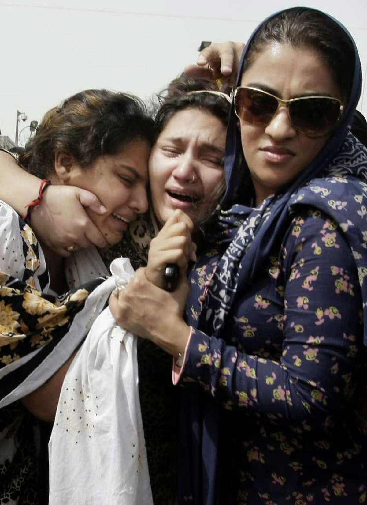Family members of acid attack victim Fakhra Younus mourn her death in Karachi, Pakistan.