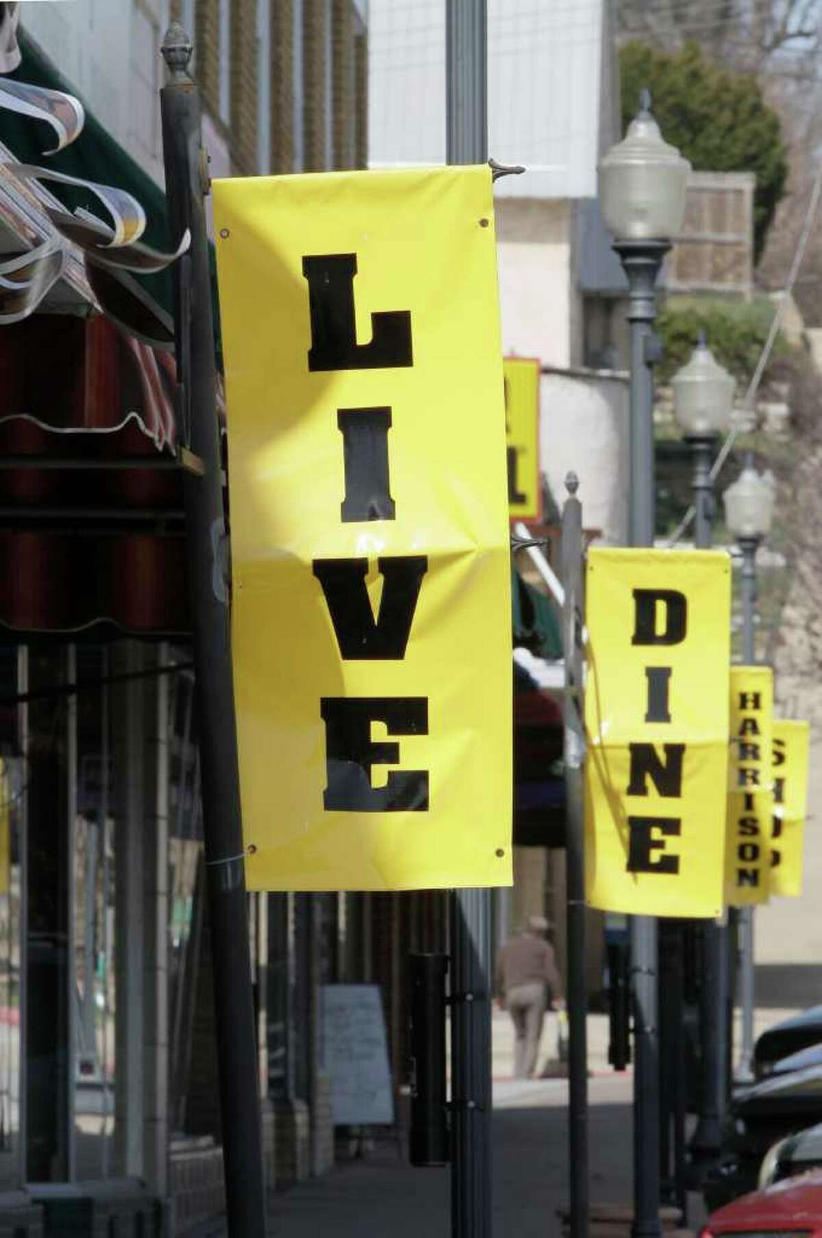 In this March 1, 2012 photo, banners line the town square in Harrison, Ark. Some residents are trying to overcome the town's reputation, earned after race riots in 1905 and 1909, when most black people were run out of town. More than a century later, only 34 of the nearly 13, 000 residents in Harrison are black. But the town hopes that a better image will attract more residents and businesses. (AP Photo/Danny Johnston)