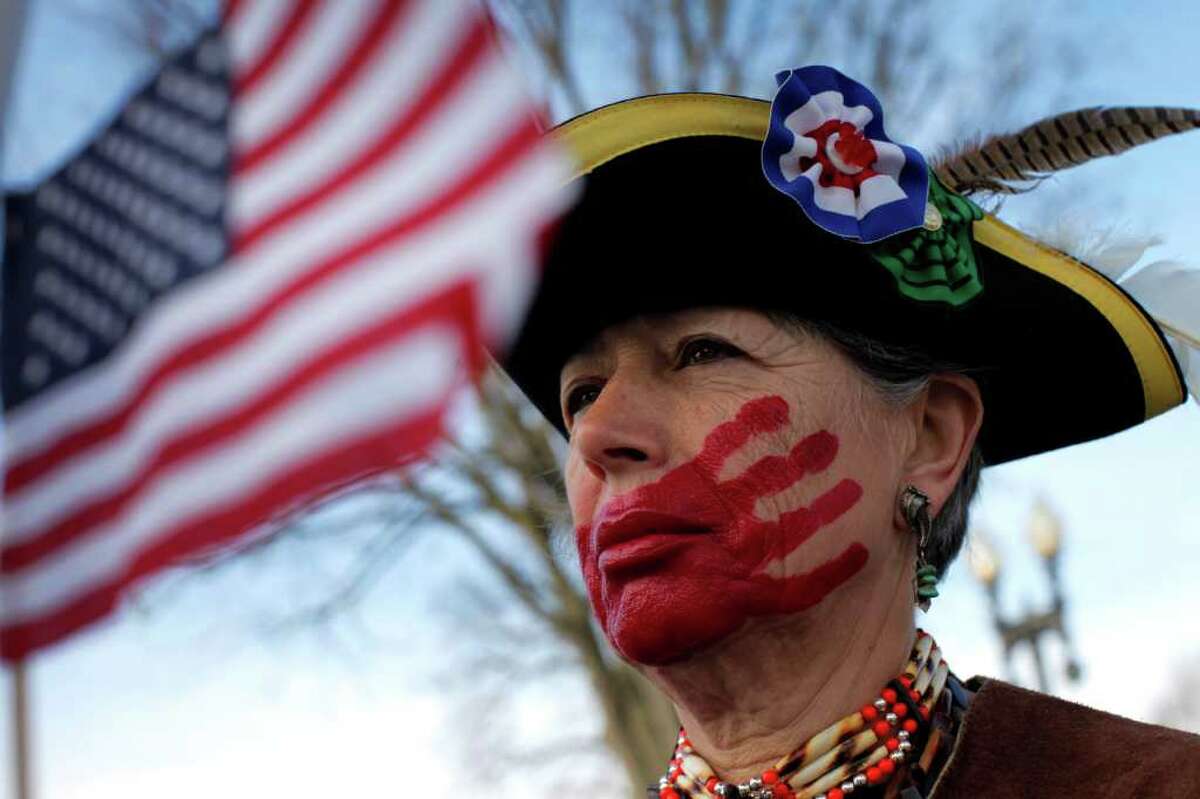 Susan Clark, of Santa Monica, Calif., painted a red hand on her mouth to show opposition to the law.