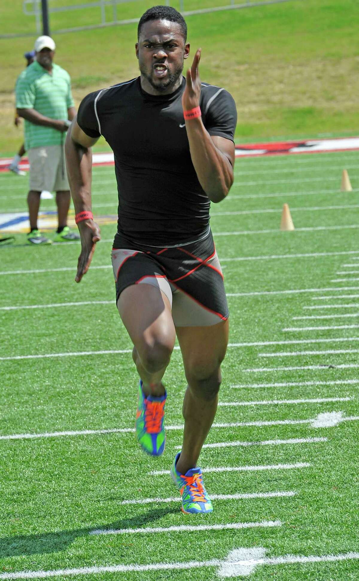 As the scouts watch, Marcus Jackson does one of his attempts at the 40 yard dash. His best time was 4.45 seconds. Lamar University football seniors J.J.Hayes, Darby Jackson, and Marcus Jackson along with others, had a chance to do football-related drills in front of nine National Football League scouts Wednesday afternoon on the playing field. Dave Ryan/The Enterprise