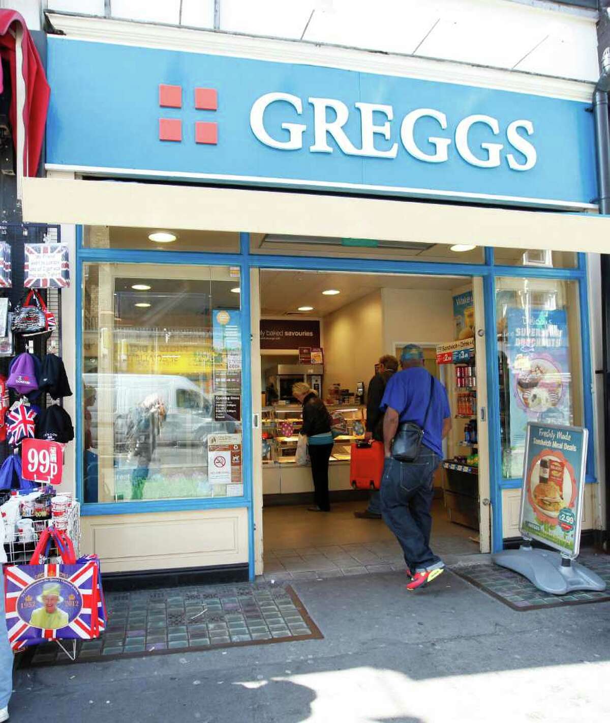 A man walks into a branch of Greggs - a chain of bakers and makers of snack food in London, Wednesday, March, 28, 2012. The boss of Greggs has accused Britain's Chancellor of the Exchequer, George Osborne, of having "lost touch" after the Chancellor admitted he could not remember the last time he bought a pasty from the baker. Chief executive Ken McMeikan said ministers did not appreciate the impact changes to VAT rules would have on ordinary people. The high street chain saw millions wiped off its shares after the Budget closed a loophole that has meant some hot takeaway foods, such as sausage rolls and pasties, escaped the duty. The move - quickly dubbed the "pie tax" - sparked outrage, with critics pointing to the contrast of a cut in the 50p top tax rate. (AP Photo/Alastair Grant)