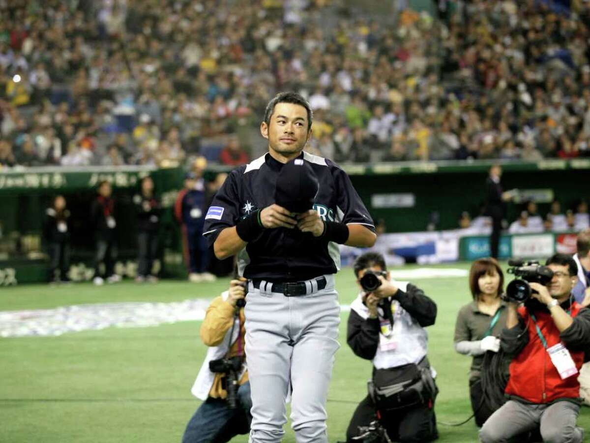 Seattle Mariners outfielders Ichiro Suzuki greets spectators during the opening ceremony of an exhibition baseball game against Japan's Hanshin Tigers at the Tokyo Dome in Tokyo Sunday, March 25, 2012. The Mariners will meet the Oakland Athletics in their two season-opening baseball games of the major league in Japan, at the Tokyo Dome from Wednesday. (AP Photo/Koji Sasahara)