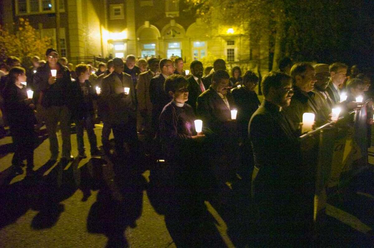 An estimated crowd of 475 files out of Stamford High School to hold a candle light vigil outside of Sen. Joseph Lieberman's Strawberry Hill Ave. apartment building in Stamford, Conn. on Sunday, Nov. 15, 2009 urging to withdraw his opposition to the public option in the health care reform bill. The event was held by the Interfaith Fellowship for Universal Health Care.