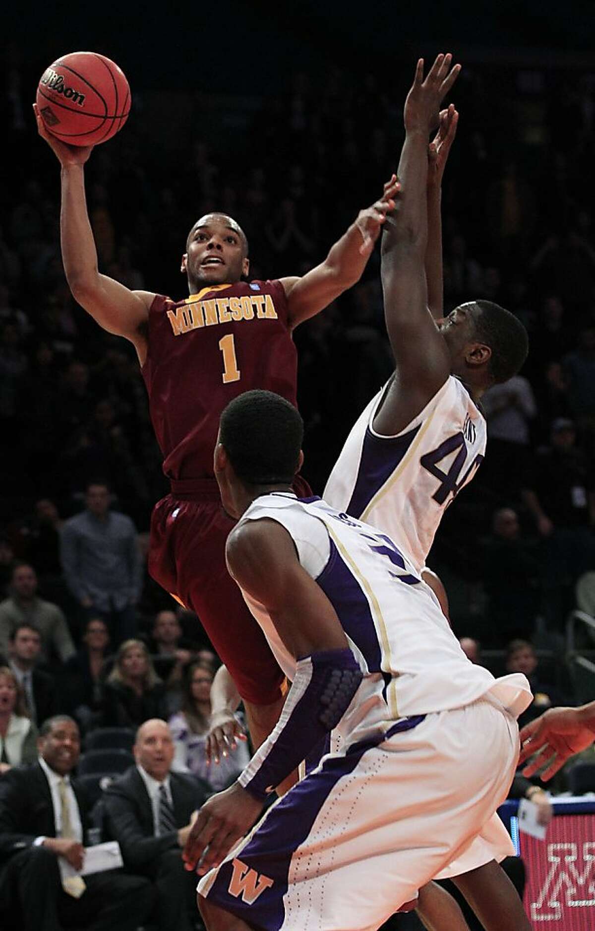 Minnesota's Andre Hollins (1) shoots over Washington's Darnell Gant during the overtime period of an NIT college basketball tournament semifinal game, Tuesday March 27, 2012, in New York. Minnesota won the game 68-67.(AP Photo/Frank Franklin II)