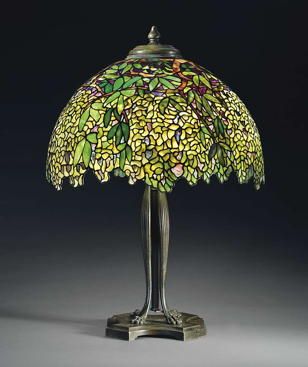 This undated photo provided by Christie's shows Tiffany's circa 1910 "Laburnum" leaded glass and bronze table lamp. The lamp, which graced San Francisco's popular Eddie Rickenbacker bar, is being sold on June 14, by Christie's auction house in New York. Eddie Rickenbacker's colorful proprietor, Norman Jay Hobday, died in February 2011. Hobday's Tiffany collection of six lamps and one chandelier is expected to bring more than $2 million. (AP Photo/Christie's)
