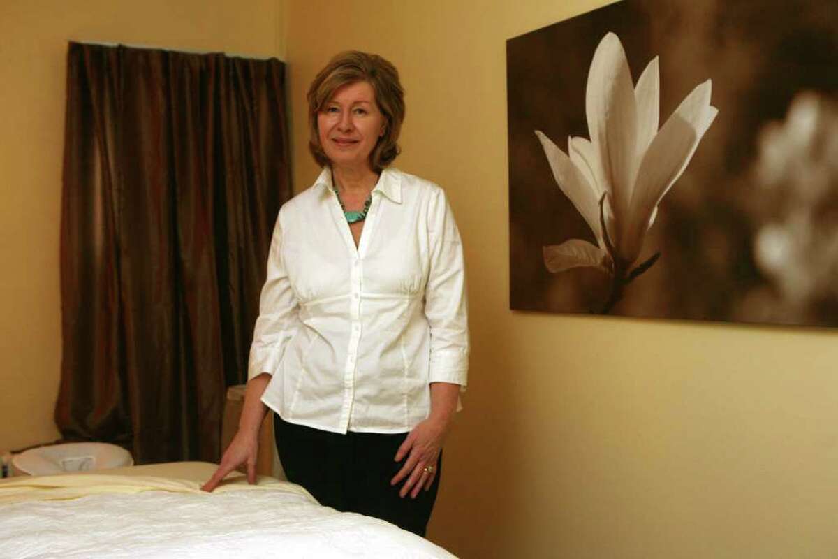 Wellness coach and founder of Wellness Wisdom Suzanne Antal-Proietti stands in her Norwalk, Conn. office which offers consultation and reading rooms and two massage rooms on Monday, March 26, 2012.