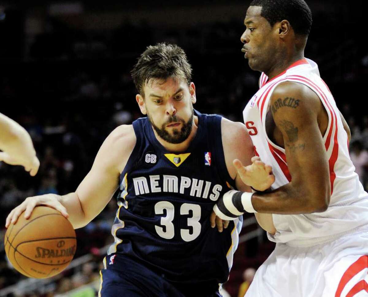 Memphis Grizzlies' Marc Gasol (33) leans into Houston Rockets' Marcus Camby, right, in the first half of an NBA basketball game, Friday, March 30, 2012, in Houston. (AP Photo/Pat Sullivan)