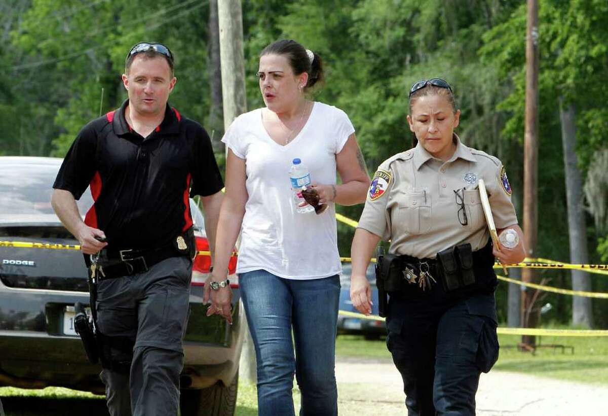 April Davis, the mother of 2½-year-old Devon Davis, is seen earlier this week with law enforcement officers as they searched along with volunteers for her son. The child went missing on Tuesday in Cleveland.