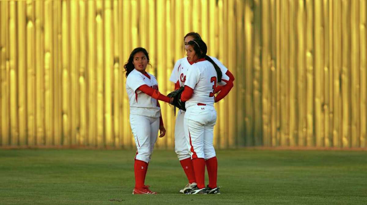 Cougar outfielders huddle before the batter is up as Canyon host Smithson Valley in softball on March 30, 2012. Tom Reel/ San Antonio Express-News