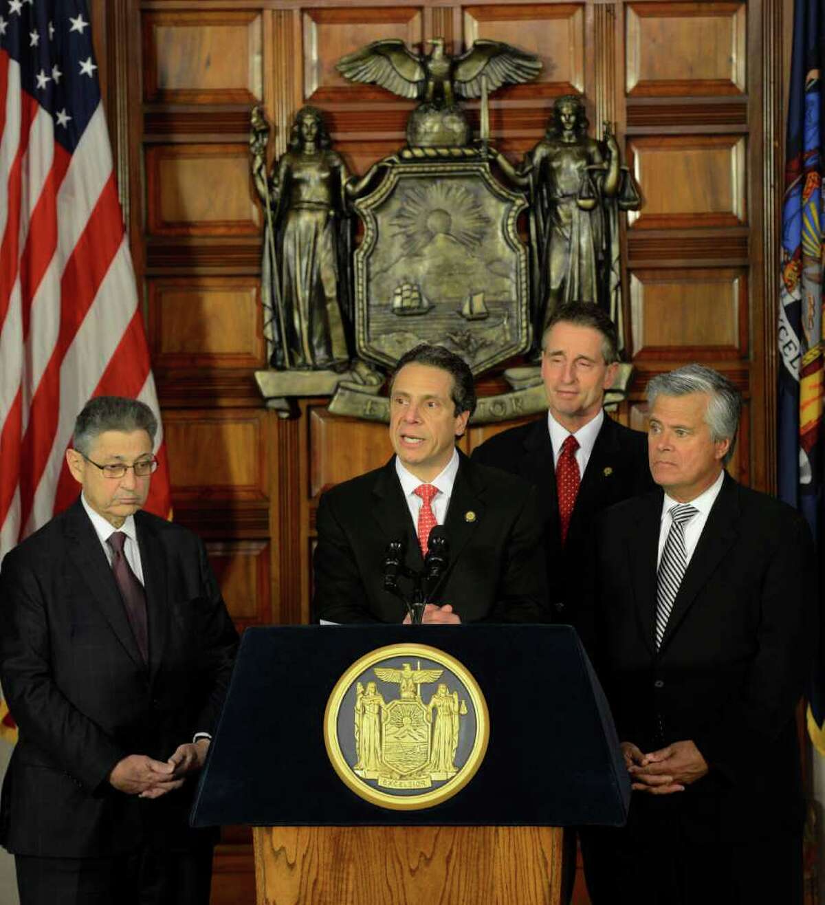 Everyone is all smiles as Assembly Speaker Shelly Silver, left joins Governor Andrew Cuomo, center and Senate Majority Leader Dean Skelos, right and Lt. Governor Bob Duffy, rear in celebrating an on-time budget during a press conference at the State Capitol in Albany, N.Y. March 30, 2012. (Skip Dickstein / Times Union)