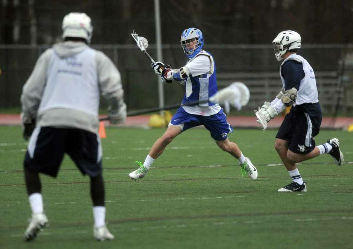 Darien's Henry West plays lacrosse against Staples during a scrimmage at Darien High School on Saturday, March 31, 2012.