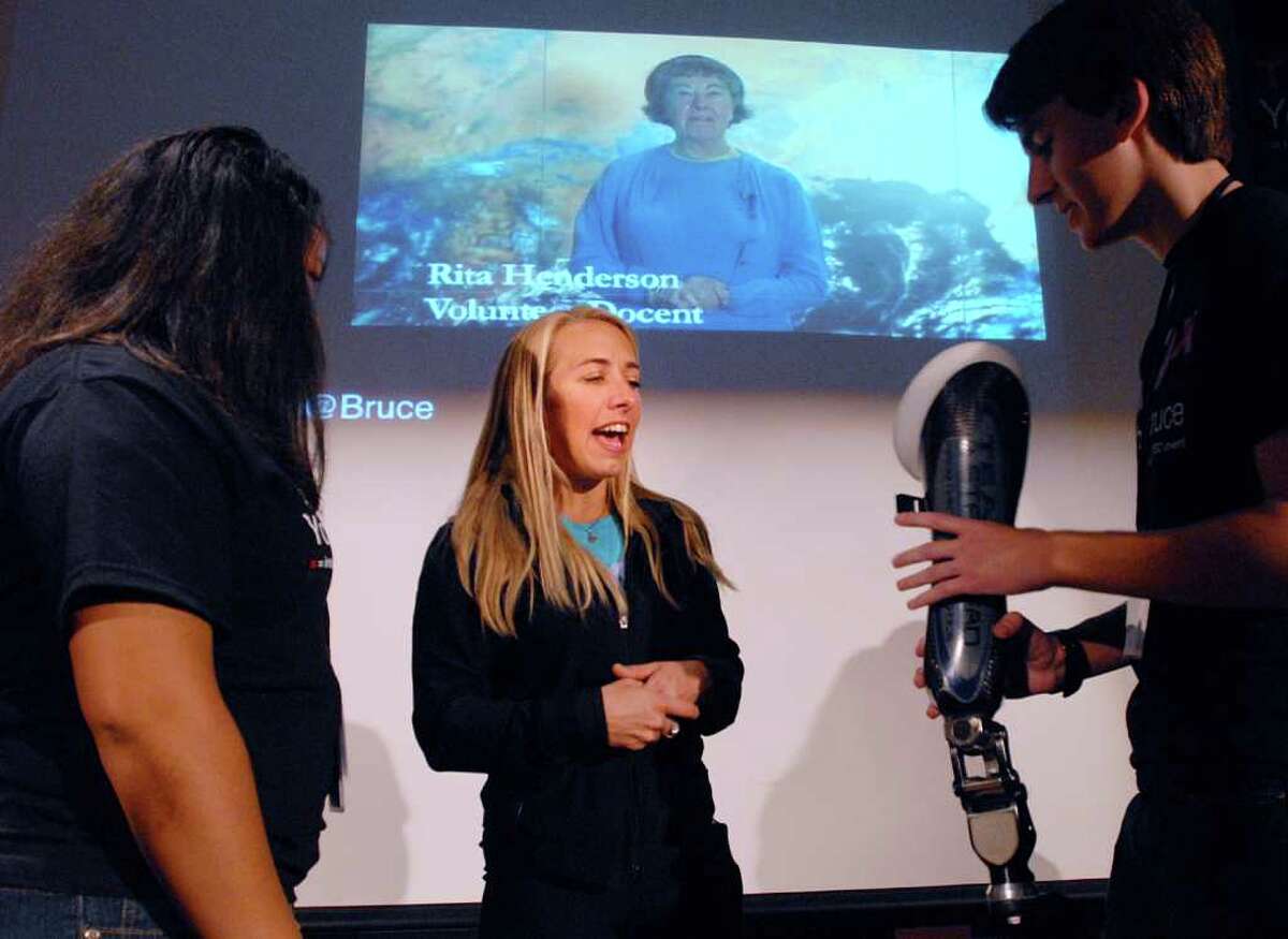 Paralympic athlete Sarah Reinertsen, center, of Orange County, Calif., shows her prosthetic leg to Greenwich High School seniors, Lisley DaSilva, left, and Gillis Baxter, holding the limb, during the event TEDxYouth@Bruce, The Olympic Spirit: Capturing the Moment at the Bruce Museum in Greenwich, Saturday afternoon, March 31, 2012. Reinertsen, who was a featured speaker at the event, said she was the first female to compete in a triahtlon using a prosthetic limb,