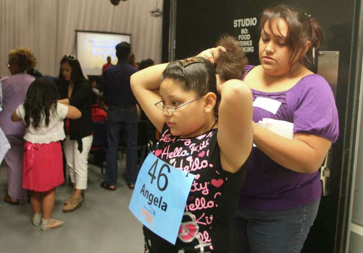 Angela Castro, 11, from Seguin Elementary is helped by her mother Silvia Acosta as she prepares for the 2012 Houston PBS Spelling Bee on Saturday March 31, 2012 in Houston, TX.