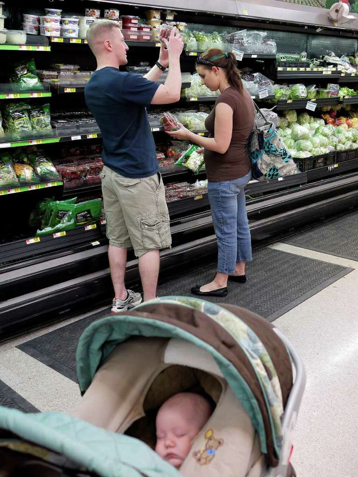 Sgt. 1st. Class Jeremy Ricketts, of Harrison, Arkansas, shops with his wife, Samantha, and son, Landen, 3-months-old, in Killeen, Texas, Saturday, March 24, 2012. Ricketts suffered brain injury in Iraq in October of 2011. Shopping was a difficult task for Ricketts, but with help from the brain injury treatment center at Fort Hood and his wife, he was able to recover.