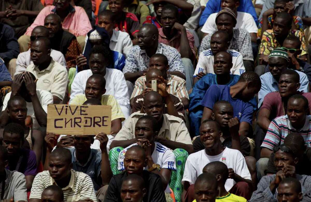 At a pro-junta rally, a man's sign reads "Long live the CNRDRE," the acronym used by the military officials that overthrew Mali's president last month.
