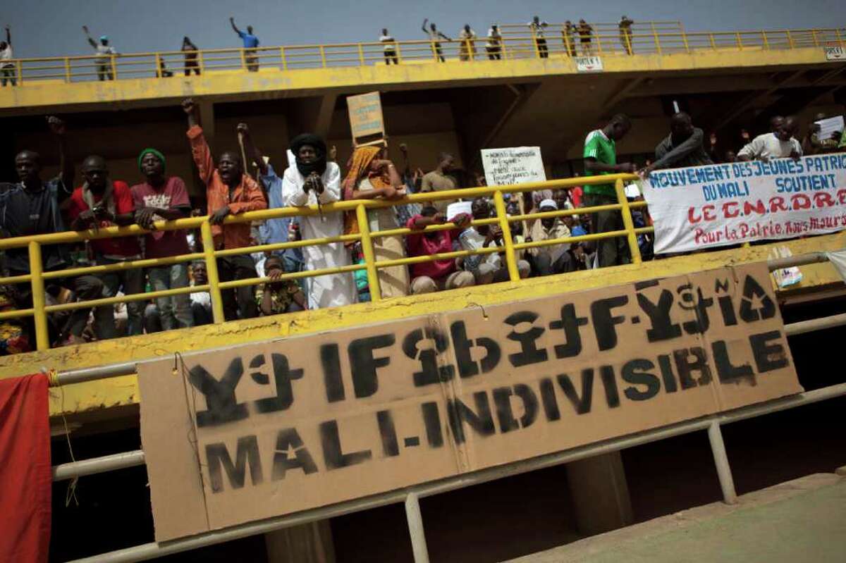 A banner reads 'Mali, indivisible,' at a rally in support of the ruling military junta attended by roughly one thousand people in a stadium with a capacity of 50,000, in Bamako, Mali Saturday, March 31, 2012. The March 26 stadium is named in commemoration of the date in 1991 when dictator Moussa Traore was overthrown, paving the way for establishment of a democracy which lasted 21 years until mutinous soldiers took power in a coup nine days ago. (AP Photo/Rebecca Blackwell)