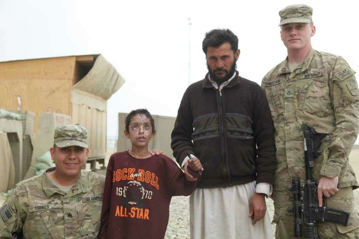 From left, Sgt. Michael Torres, 8-year-old Mateen, his neighbor Sultan, and Pvt. Cody Sandstrom in Paktika Province. Mateen was blinded by a blast when his Taliban father's homemade bomb exploded. American troops saved the child.