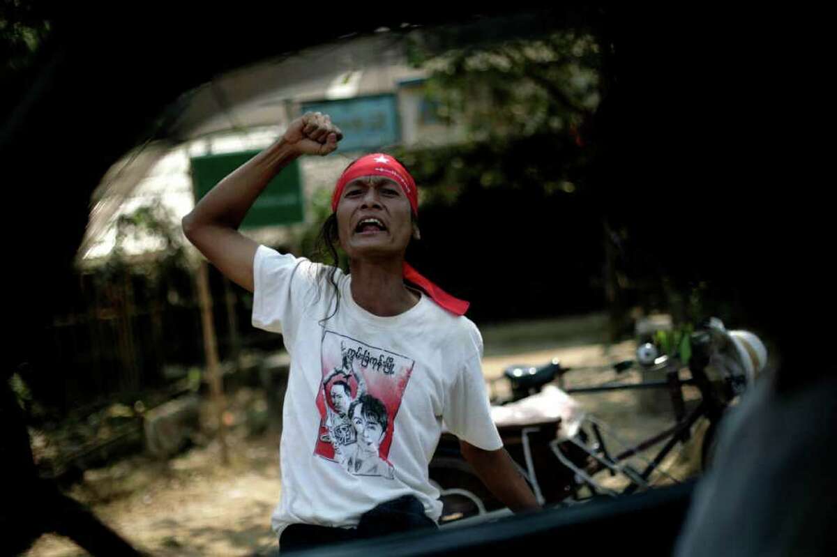 A supporter of Myanmar's pro-democracy leader Aung San Suu Kyi, shouts slogans during an election campaign a day before the country's by-elections in the village of Wah Thin Kha, Myanmar, Saturday, March 31, 2012. (AP Photo/Altaf Qadri)
