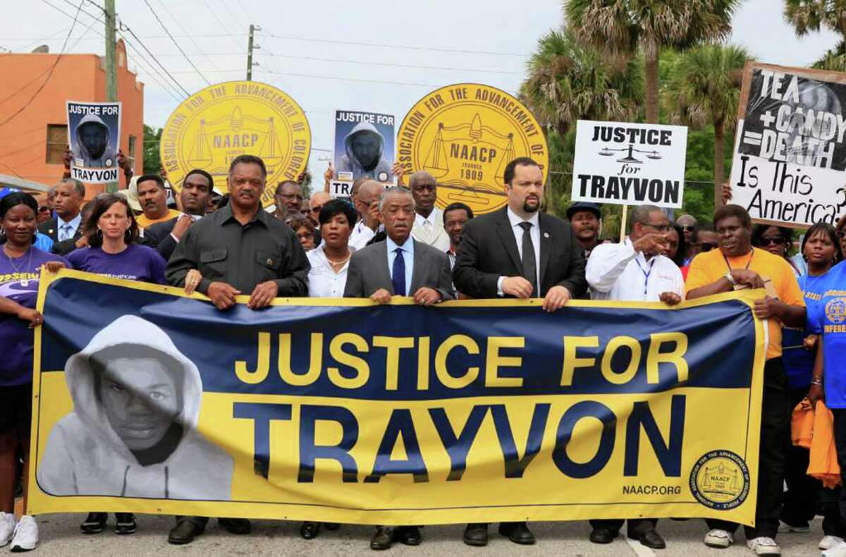 From left, Rev. Jesse Jackson, Rev. Al Sharpton, and Benjamin Jealous, President of the NAACP lead the march for slain Florida teenager Trayvon Martin on Saturday, March 31, 2012 in Sanford, Fla. Protesters carried signs, chanted ?Justice for Trayvon,? and clutched the hands of their children while they walked from Crooms Academy of Information Technology, the county?s first high school for black students, to the Sanford Police Department. The march was organized by the NAACP and was one of several taking place over the weekend. Martin was shot to death by 28-year-old George Zimmerman on Feb. 26 as he walked from back from a convenience store to his father?s fiancée?s home in a gated community outside Orlando. (AP Photo/Julie Fletcher)