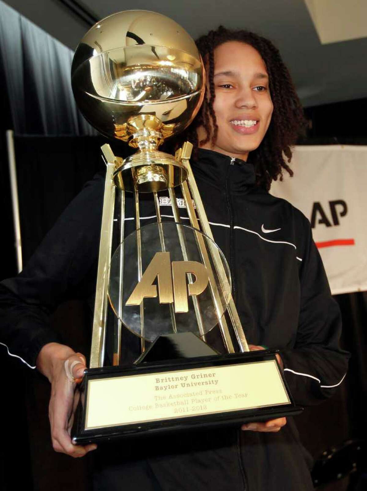 Baylor center Brittney Griner holds up The Associated Press women's college basketball player of the year trophy during an awards ceremony before the NCAA Women's Final Four basketball tournament in Denver, Saturday, March 31, 2012. (AP Photo/David Zalubowski)