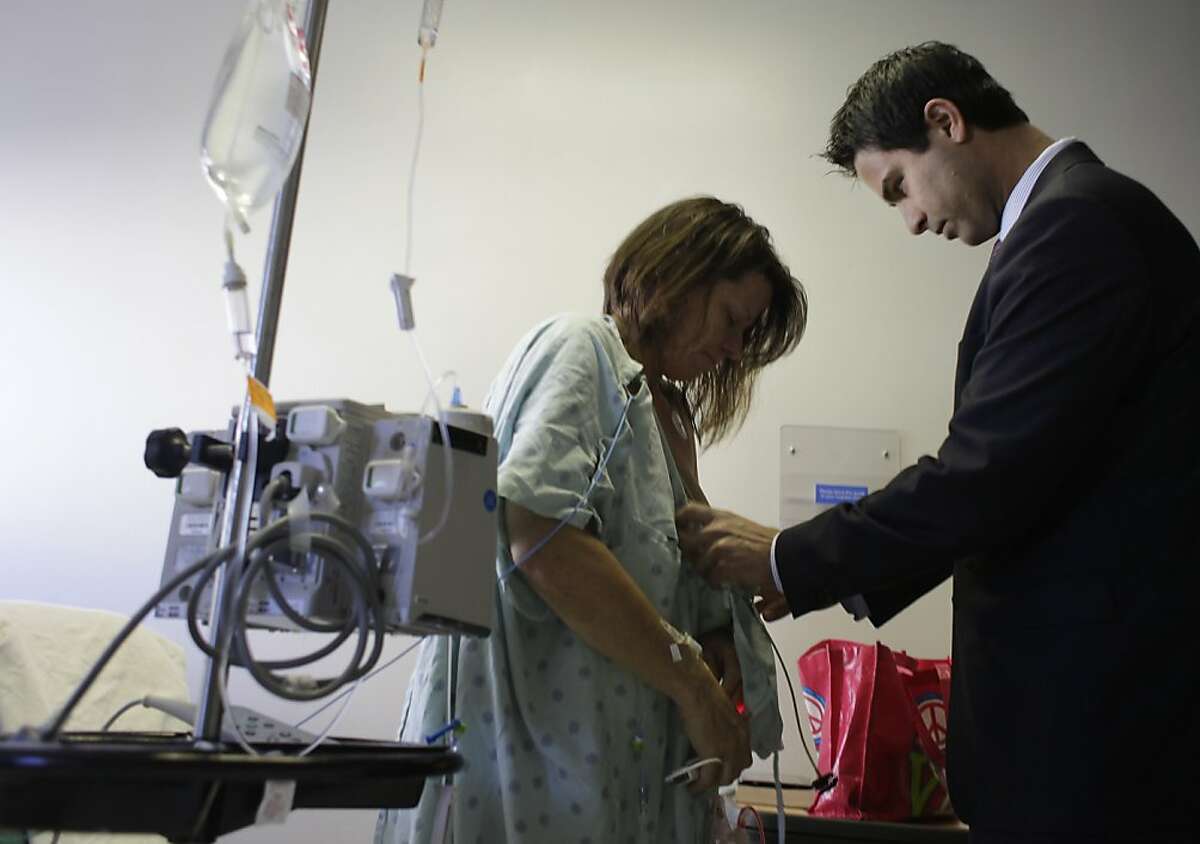 Dr. Hani Sbitany (right) checks on Lori MacKenzie's (left) incisions as she recovers at Mt. Zion Hospital Helen Diller Cancer Center after her DIEP Flap Breast Reconstruction procedure on Wednesday, February 24, 2012 in San Francisco, Calif.