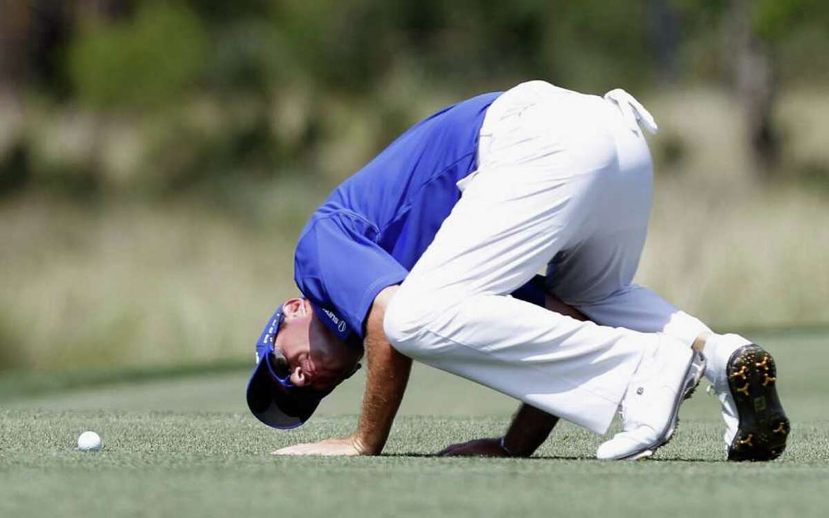 HUMBLE, TX - MARCH 31: Brian Davis of England inspects his ball before his second shot on the second hole during the third round of the Shell Houston Open at Redstone Golf Club on March 31, 2012 in Humble, Texas.