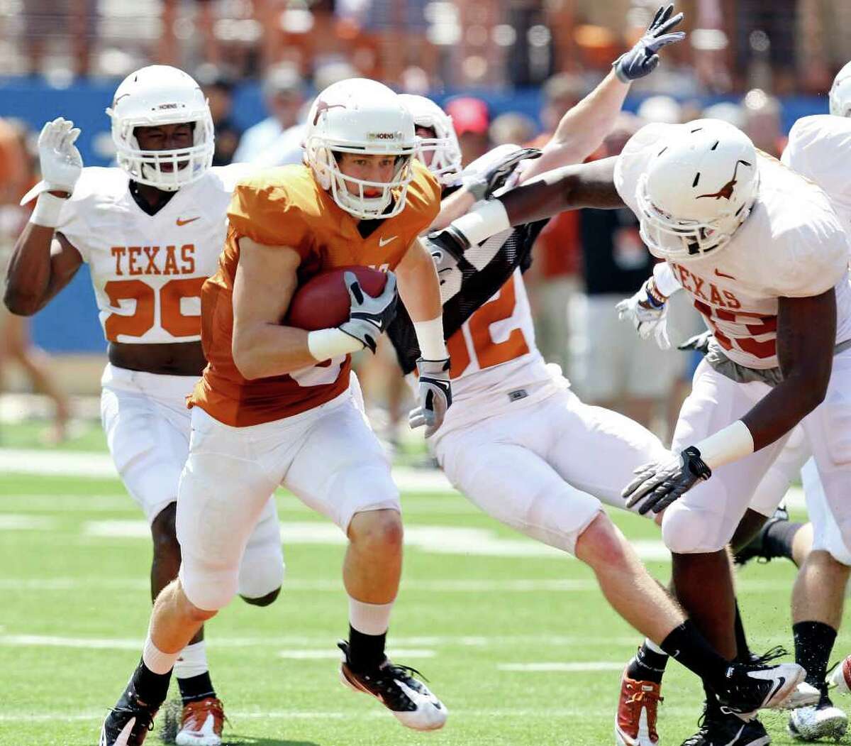 Receiver Jaxon Shipley (second from left), heading upfield in Texas’ spring game, may have outdone the QBs with a 54-yard TD toss to D.J. Grant.