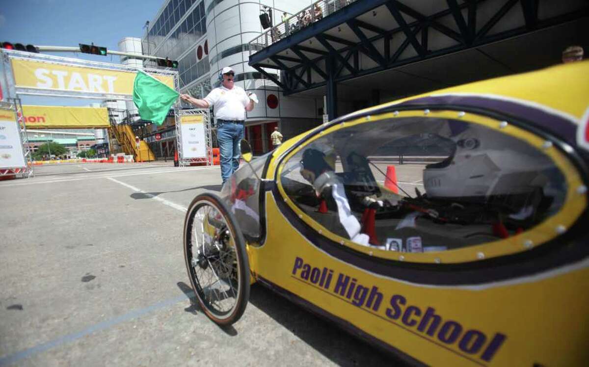 A prototype vehicle starts it's laps around the track around Discovery Green during the Shell Eco-Marathon Americas 2012 on Sunday, April 1, 2012, in Houston. Cars of the future, as high school, university, and college students test vehicles they have designed and built to see which can go the farthest distance using the least amount of fuel.
