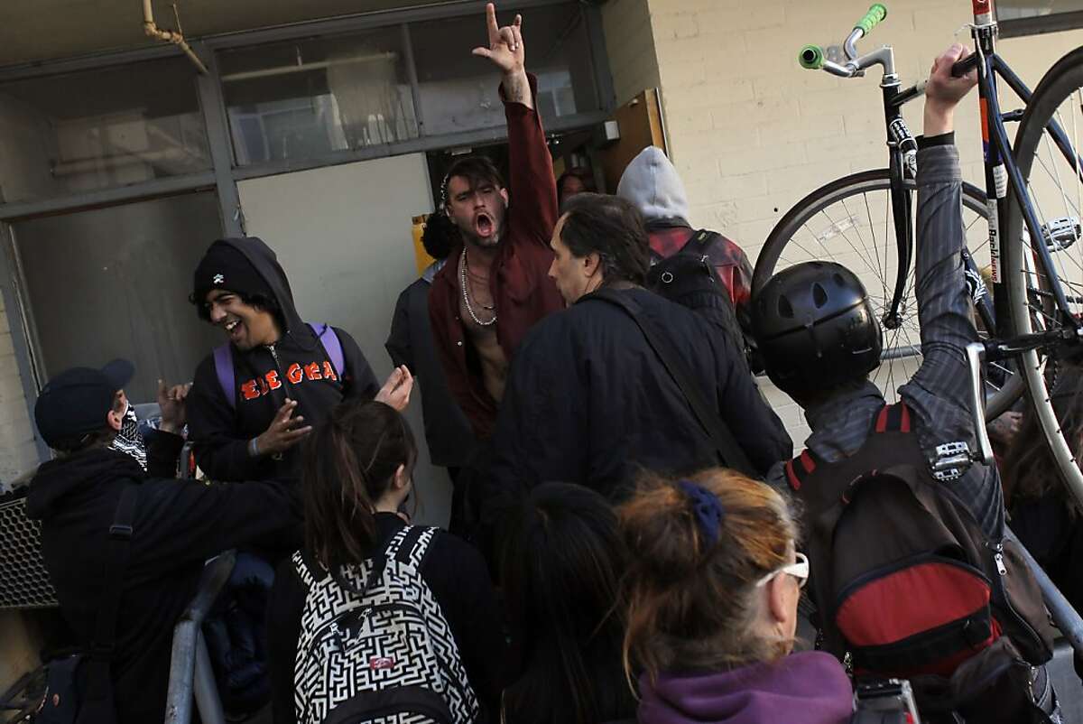 Occupy San Francisco protesters react as they take over a building at the corner of Turk and Gough Streets in San Francisco, Calif., on Sunday, April 1, 2012, following a rally at Union Square and march up Geary.