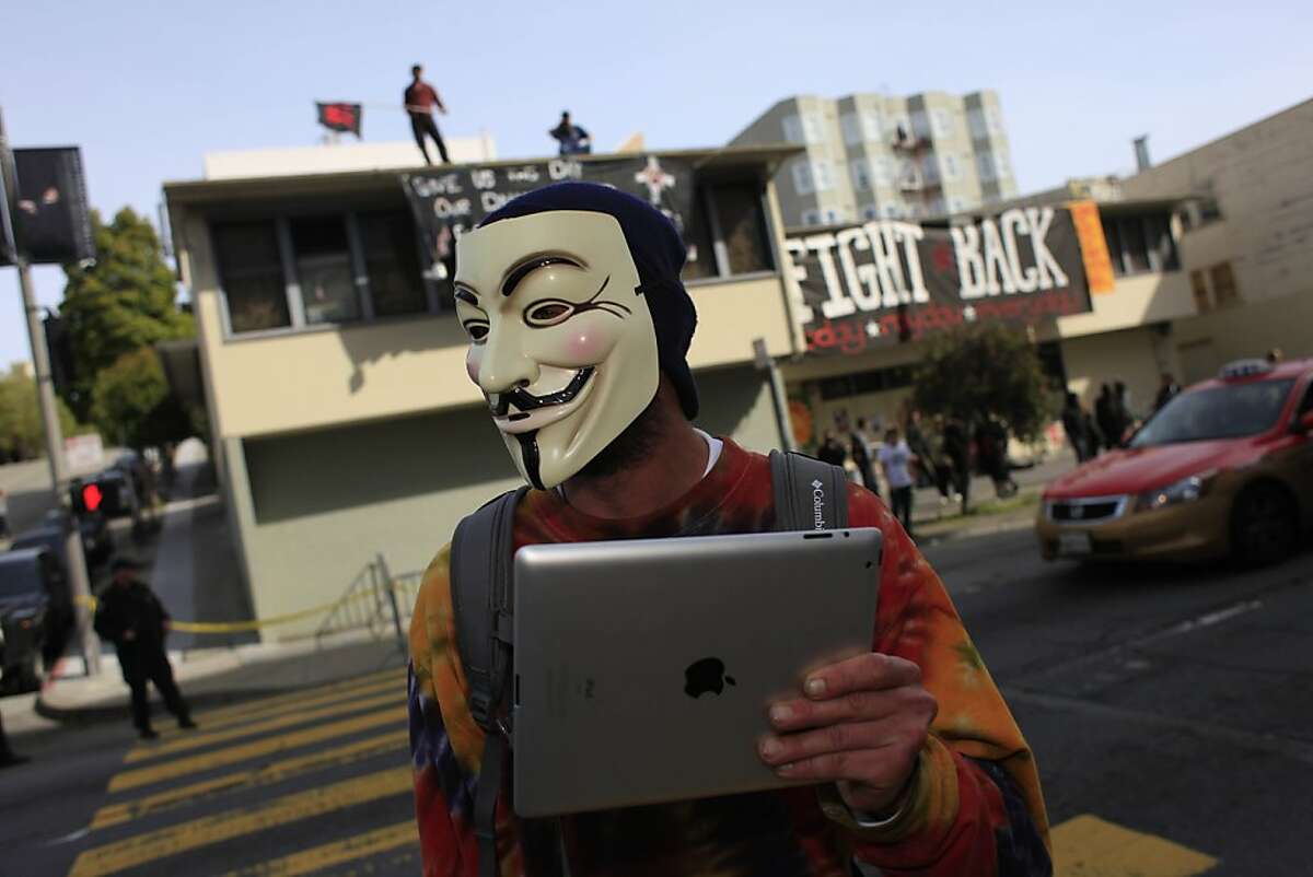 An Occupy supporter stands in across from 888 Turk Street which had been taken over by protesters the day before on Monday, April 2, 2012 in San Francisco, Calif.