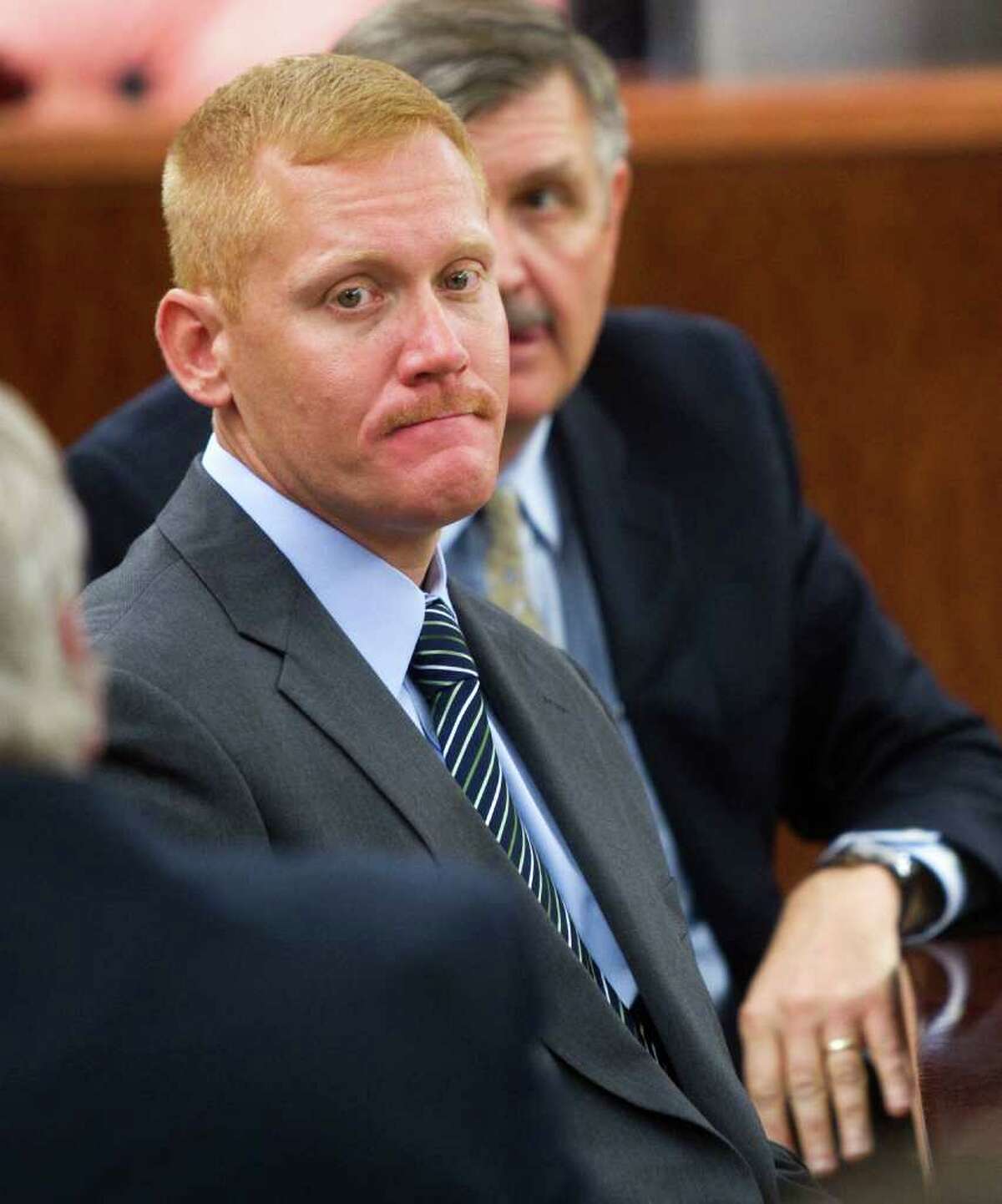 Bellaire Police Sgt. Jeff Cotton sits in the 232nd District Court before opening arguments in his trial Wednesday, May 5, 2010, in Houston. Cotton, 40, is on trial for aggravated assault by a public servant for a shooting incident, where he stands accused for shooting Robert Tolan in his parents' driveway. ( Brett Coomer / Houston Chronicle )