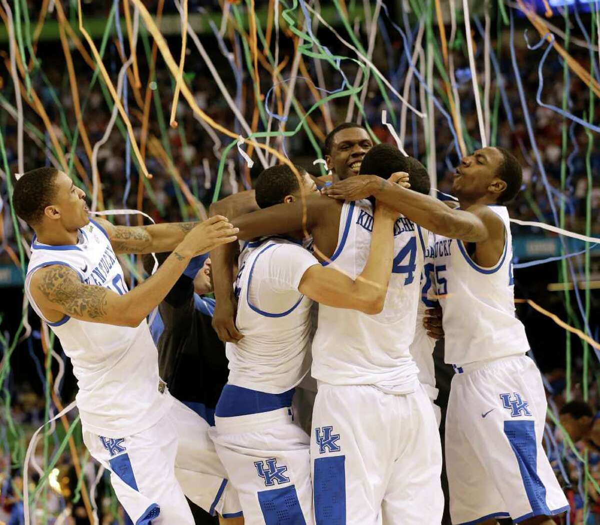 Kentucky players celebrate the school's eighth national title - and first since 1998 - after defeating Kansas on Monday.