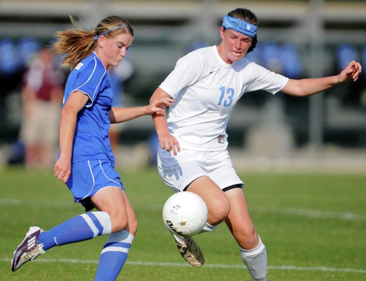 New Braunfels' Rebekah Kensing (left) and Johnson's Bridget Gleason (13) battle for a ball during a bidistrict playoff match between the Johnson Jaguars and the New Braunfels Unicorns at the Blossom Athletic Center West Soccer Field on Monday, April 2, 2012.