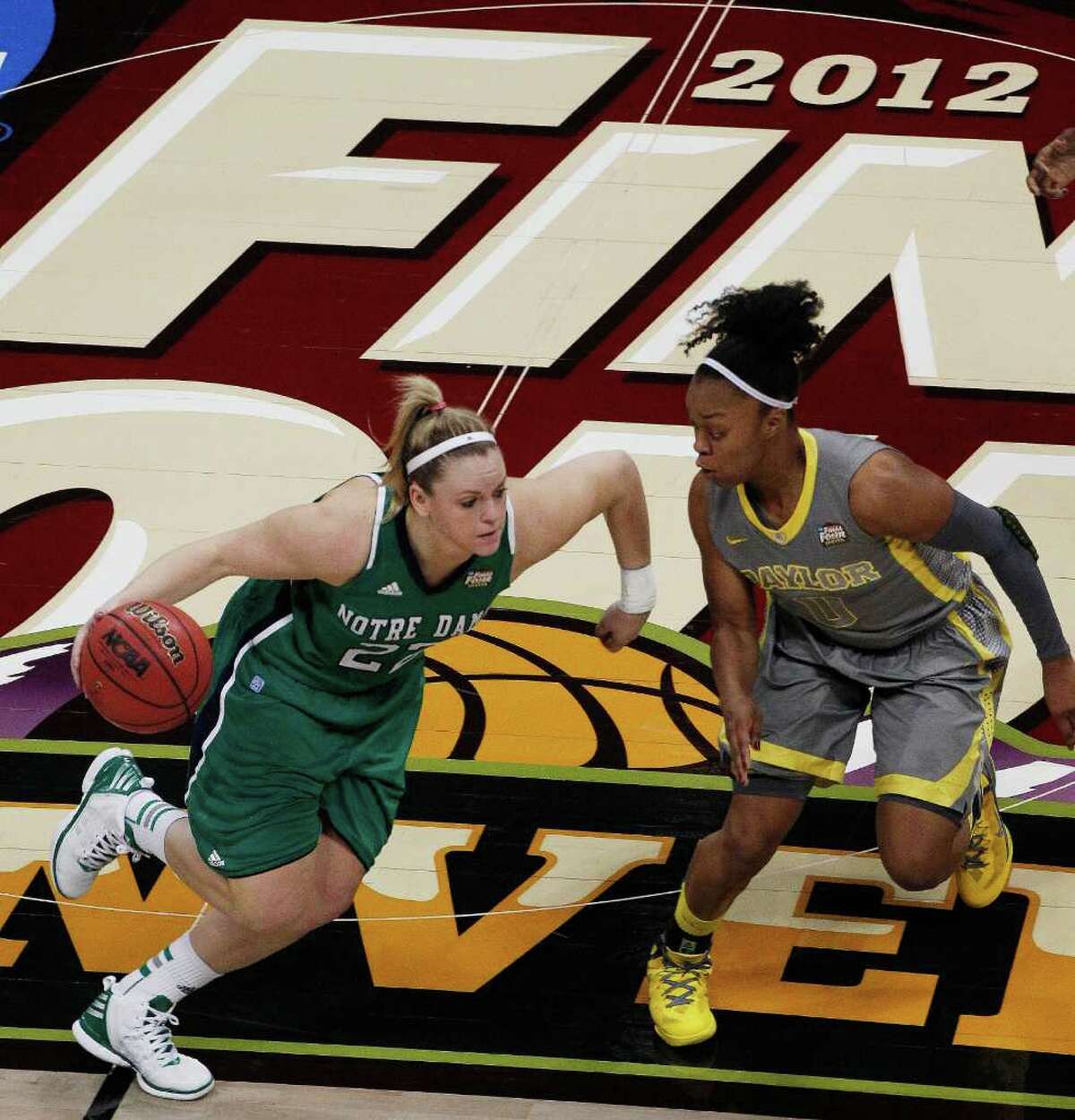 Notre Dame guard Brittany Mallory (22) drives past Baylor guard Odyssey Sims (0) during the first half in the NCAA women's Final Four college basketball championship game, in Denver, Tuesday, April 3, 2012. (AP Photo/David Zalubowski)