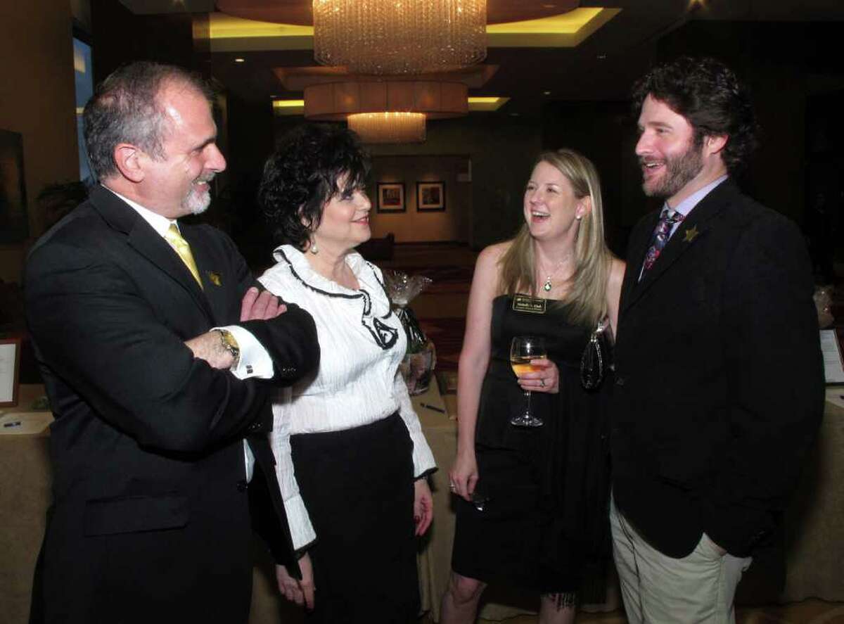 OTS/HEIDBRINK - Advisory board member Tim D'Antonio, from left, executive director Pamela Taylor, board president Michelle Clark and donor Chisum Pierce mingle at the Dress For Success 10 year celebration at the Grand Hyatt Hotel on 3/28/2012. names checked photo by leland a. outz