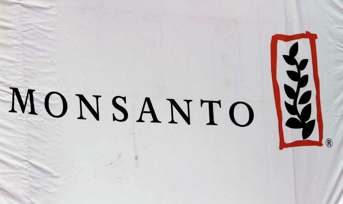 FILE - This Aug. 31, 2011 photo, shows the Monsanto corporate logo at their exhibit booth during the Farm Progress Show, in Decatur, Ill. Monsanto Co. said Wednesday, April 4, 2012 that a strong and early U.S. seed selling season drove its fiscal second quarter net income up 19 percent. The U.S. agricultural giant also raised its earnings outlook for the full year. (AP Photo/Seth Perlman)