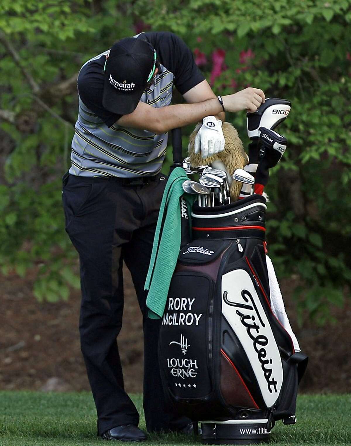 ADVANCE FOR WEEKEND EDITIONS, MARCH 31-APRIL 1 - FILE - In this April 10, 2011, file photo, Rory McIlroy of Northern Ireland, leans on his golf bag on the 13th hole during the final round of the Masters golf tournament in Augusta, Ga. McIlroy started the final round with a four-shot lead and shot 80. (AP Photo/Matt Slocum, File)