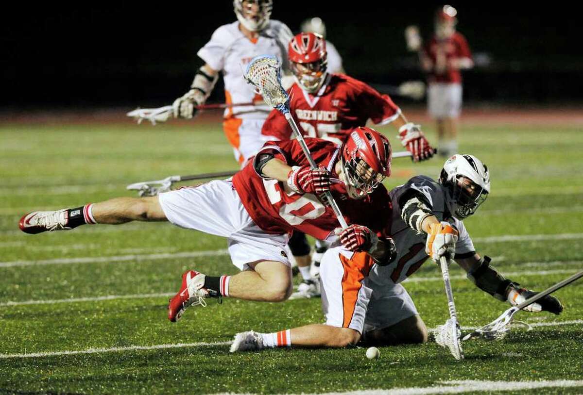 Greenwich's Shawn Dunster collides with Ridgefield's Eric Scala during their game at Ridgefield High School on Wednesday, April 4, 2012. Ridgefield won 11-4.