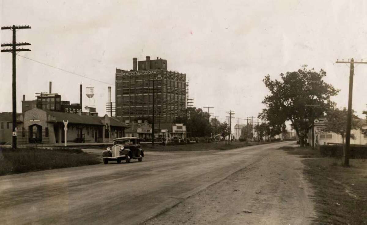 This photo from the summer of 1934 shows the view looking down U.S. 90A in front of the Imperial Sugar refinery in Sugar Land.